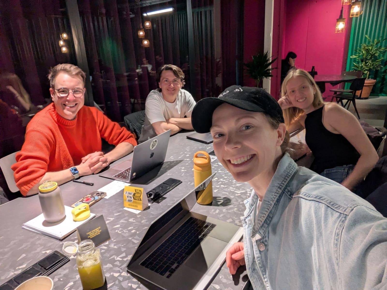 Founders working side by side on laptops at an evening coworking session in Amsterdam.