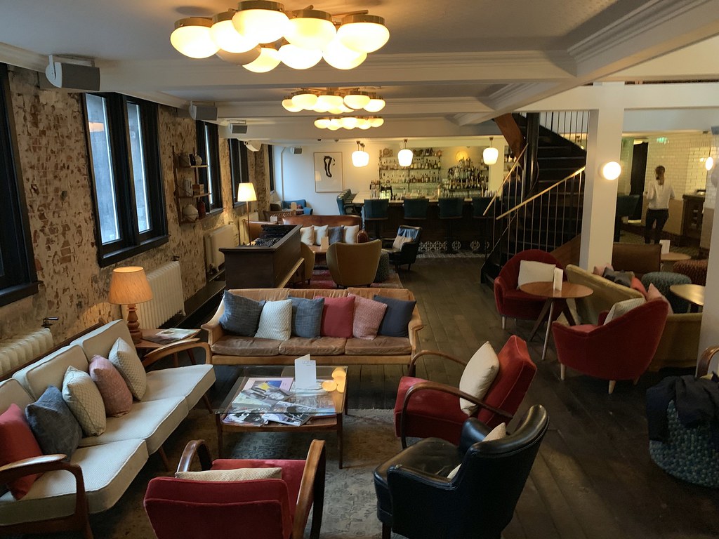 The lounge at The Hoxton, with sofas, armchairs and low tables
